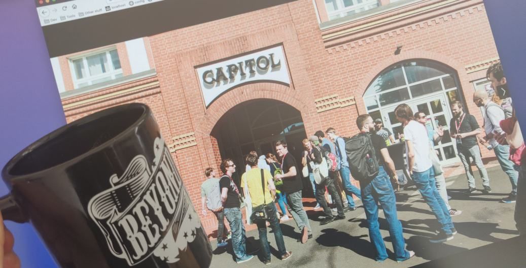 photo on a screen of Beyond Tellerrand Capitol Theatre Düsseldorf and coffee mug